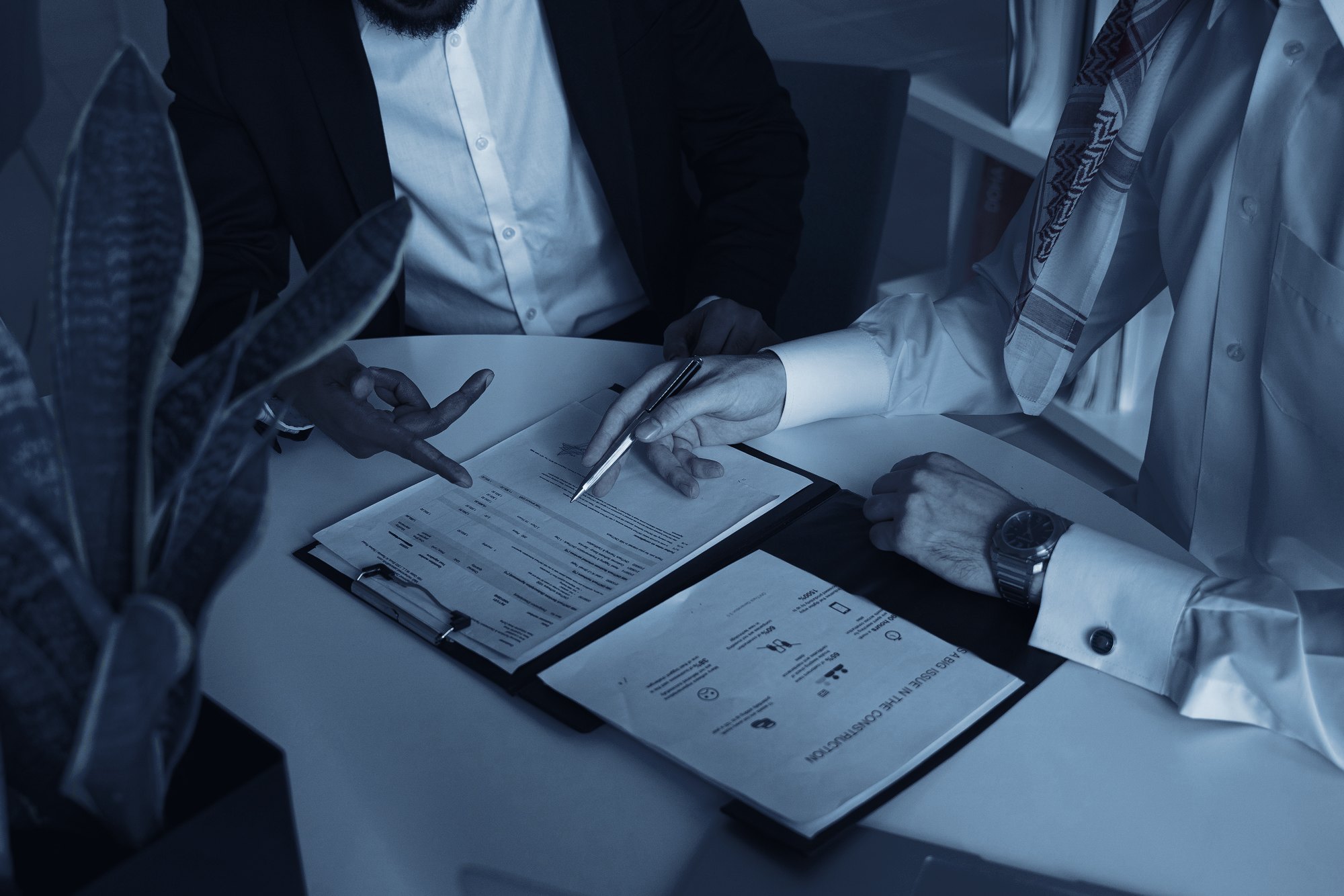 Two people reviewing a document over a table